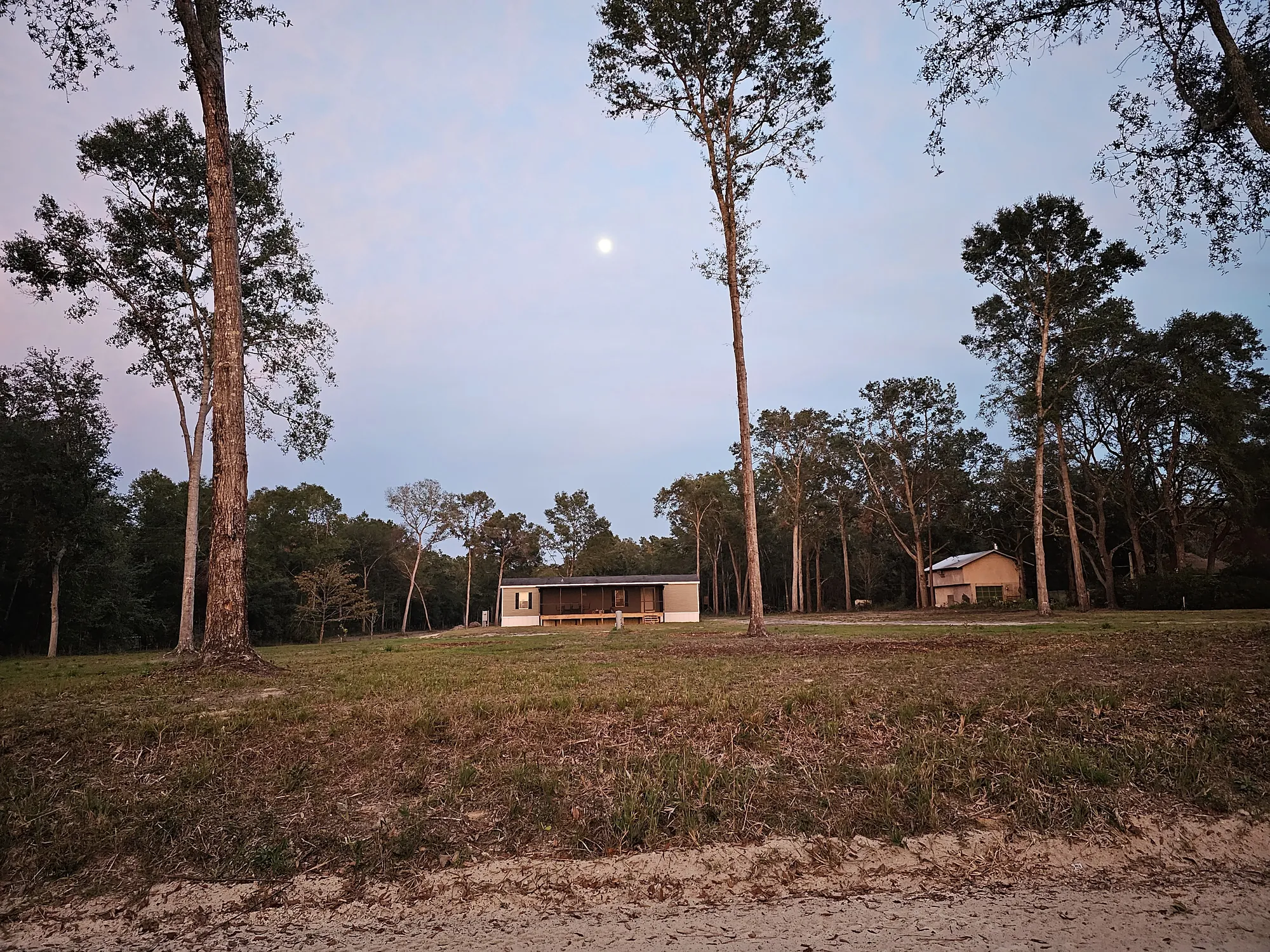 Mobile home placed on a fully prepared rural Florida site at dusk