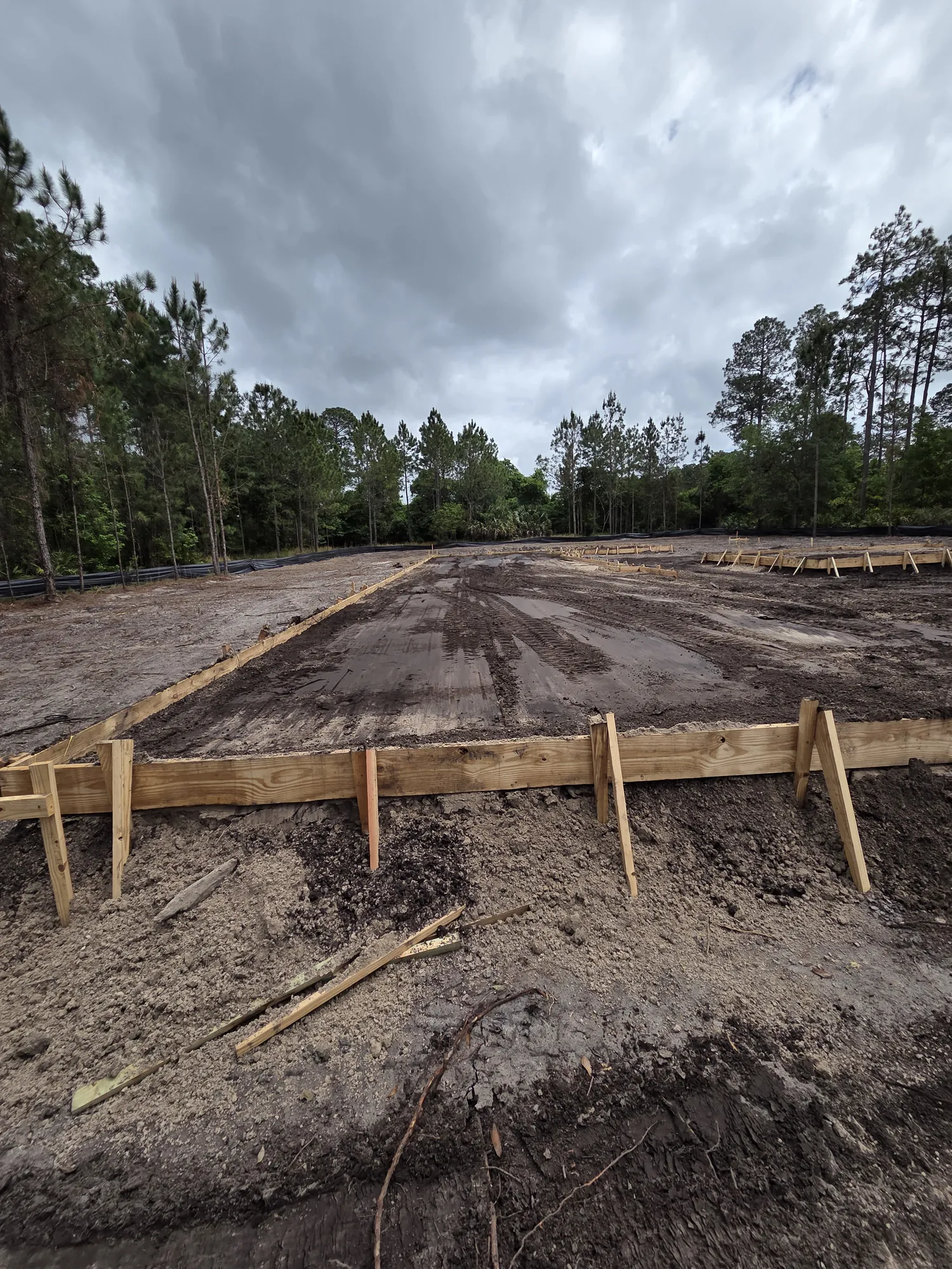 Mobile home pad with wooden forms ready for finishing on a rural Florida lot