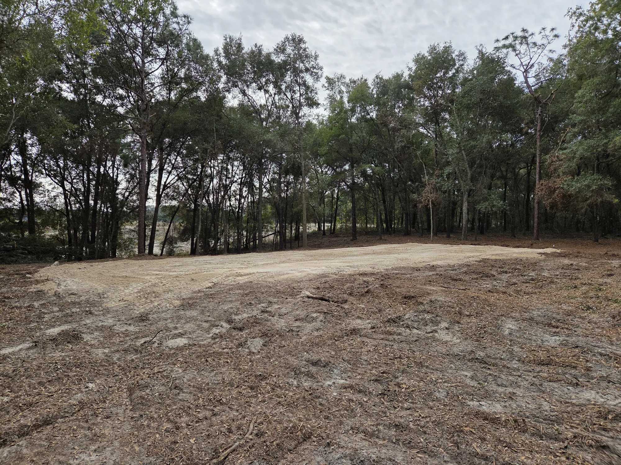 Cleared dirt pad on Lake City property, ready for construction