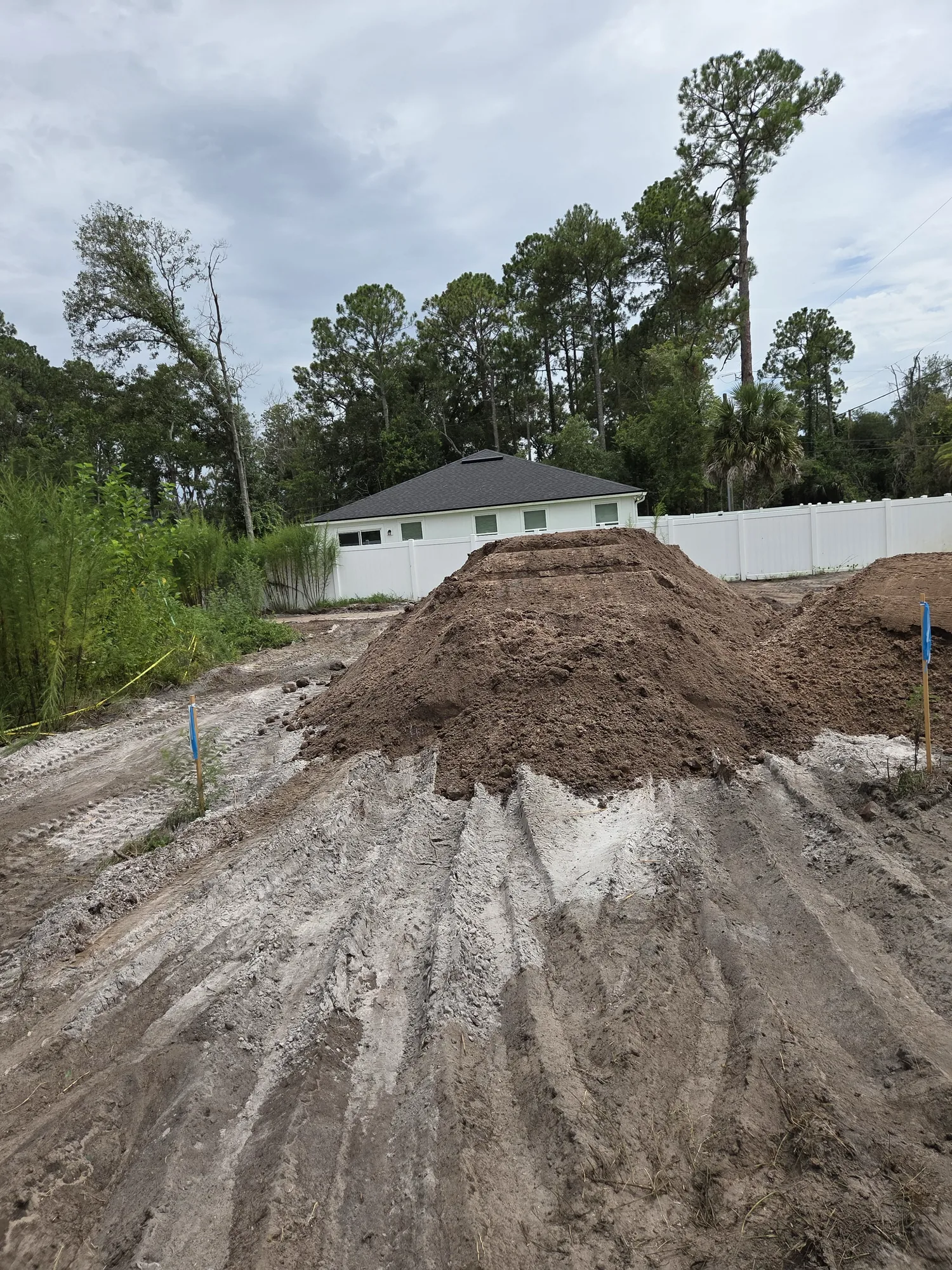 Mound of fill dirt on a graded pad behind a North Florida home