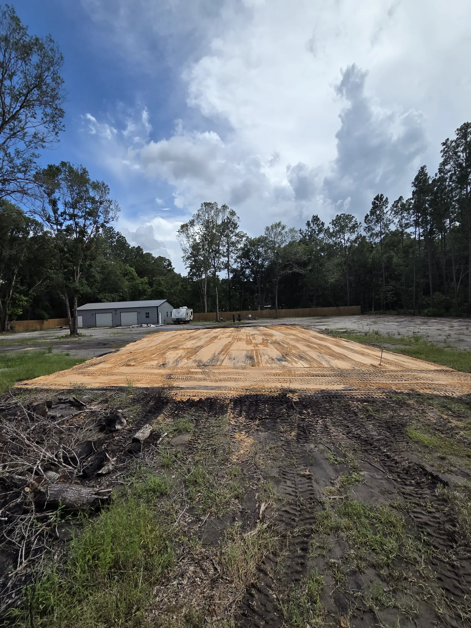Raised sand pad built up and compacted for a structure on a North Florida property